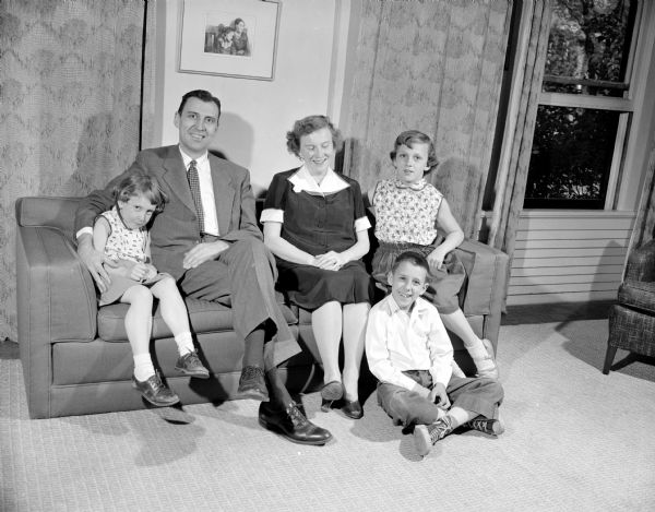 Judge James E. Doyle family group portrait taken for his Democratic campaign for governor. Taken at the family home at 216 Campbell Street. Shown are son James (sitting on the floor) and daughters, Mary and Catherine, sitting on the couch with Ruth and James Doyle.