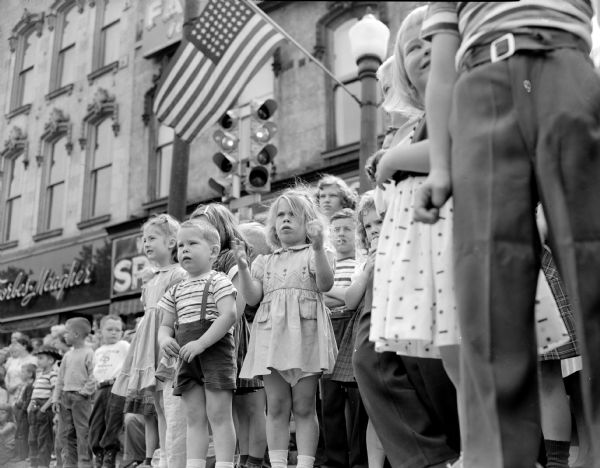 Children lining the street for the Memorial Day parade around Capitol Square.