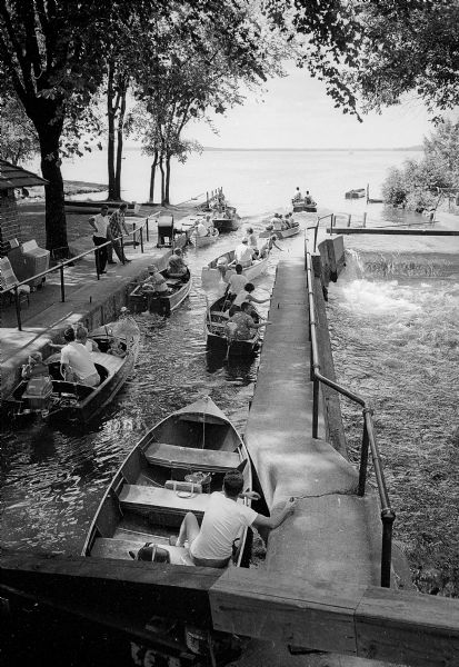 Boaters and fishermen on the Yahara River moving into Lake Mendota just after the water reached exit level at the Tenney Park lock.