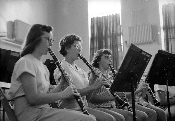 Three clarinetists during a band practice at the University of Wisconsin Music Clinic. They are Joanne Wallner of Wisconsin Rapids, Beverly Babas of Algoma, and Marjorie Gozdik of Elgin, Illinois.