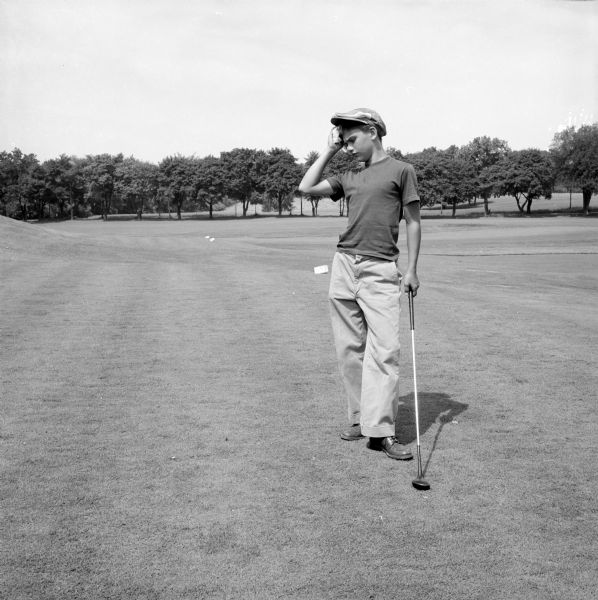 Portrait of Steve Plater, to make a composite image that was published in the newspaper of him standing with his golf club at the Maple Bluff golf course with an enlarged golf ball "sweating out the thought of driving an oversized ball."