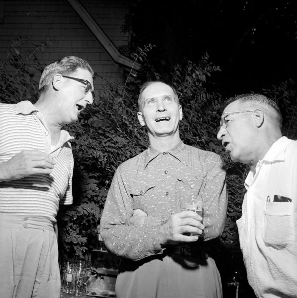 City Clerk A.W. Barels (left), City Attorney Harold Hanson, and Alderman Norman Moll are shown singing at Alderwoman Ethel Brown's picnic.