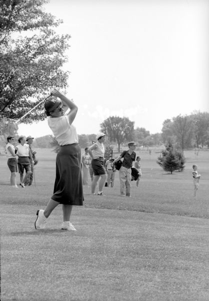 Joyce Ziske, 1952 women's golf champion, lifts a short iron shot onto the green during the 42nd annual state tournament of the Wisconsin Women's Golf Association at Blackhawk Country Club.