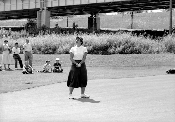 oyce Ziske, 1952 women's golf champion, celebrating sinking a putt at the Blackhawk Country Club. She is competing in the 42nd annual state tournament of the Wisconsin Women's Golf Association.