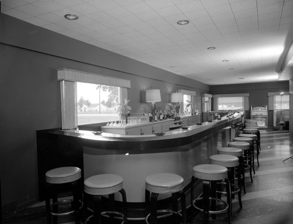 The bar in the New Pines restaurant at 2413 Parmenter Street. Stools wrap neatly around the slightly curved bar.