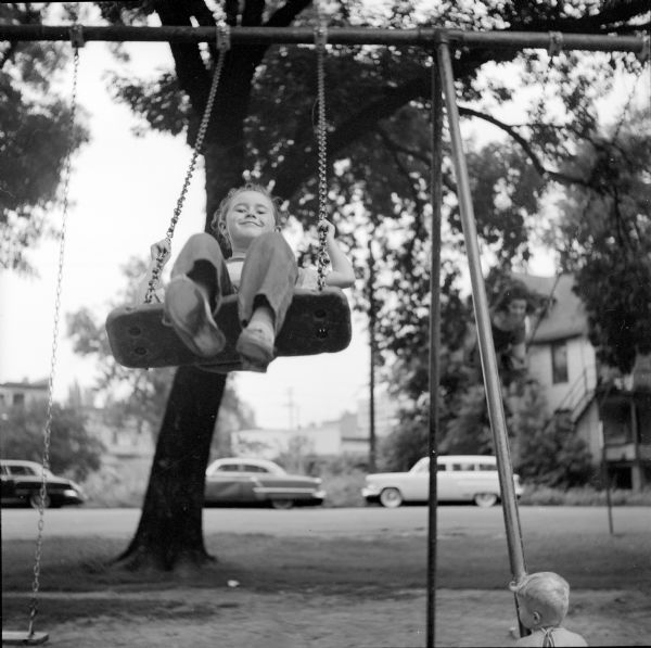 Mary Jane Caruso (of 780 Gwinnett Court) is shown playing on a swing at Brittingham Park.