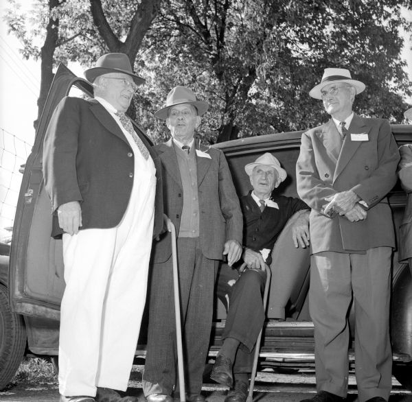 John Philpot (standing with cane) asking Herman Woerpel if he'd put on a little weight! Looking on is Edward Duschek, sitting in the driver's seat of a car with his cane. The unknown person on the far right was originally cropped out for publishing in the newspaper.
