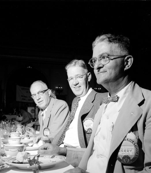 Three past presidents of Madison Optimist clubs are shown at a dining table. Left to right are: Walter Blair, B.R. L'Hommedieu, and Jerry Coulter. Coulter also served as Optimist secretary from 1931 to 1954. Some 200 Optimist members from Madison's three clubs attended the meeting. 
