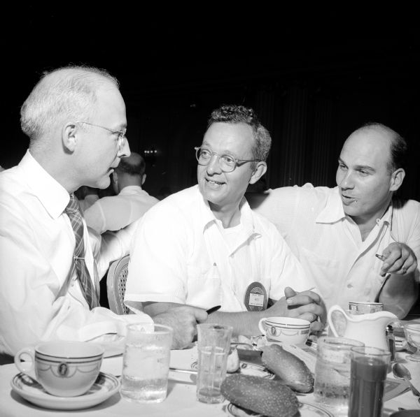 Three Optimists chatting over coffee (left to right): W.C. Matthews, Wesley West, and Joseph Melli.