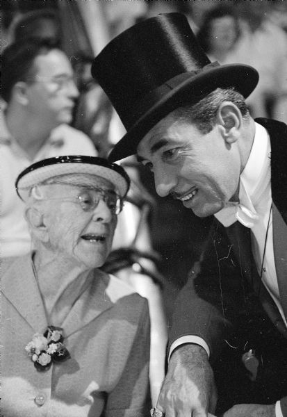 Talking to the ringmaster at a Ringling Brothers-Barnum and Bailey Circus show is 96 year-old Nellie Kedzie Jones, an educational pioneer and Home Economics Extension leader at the University of Wisconsin.
