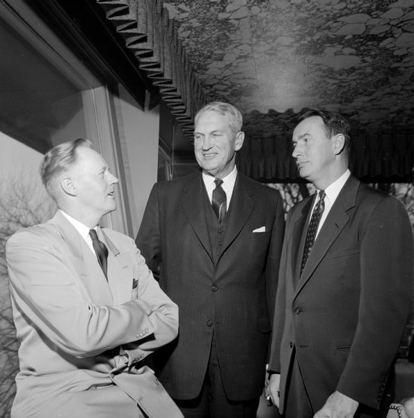 Representatives of business, labor and government meet at a pre-luncheon gathering at the Edgewater Hotel to celebrate the opening of a new Sears store. Standing left to right are: Lawrence J. Larson, president of Madison Chamber of Commerce; F.M. Mc Connell, president of Sears Roebuck & Co.; and F. Goff Beach Jr., Oscar Mayer & Co. vice president.