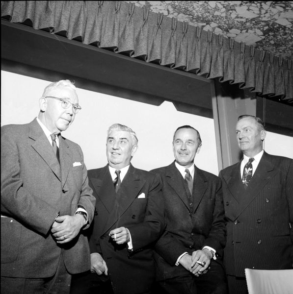 Representatives of business, labor and government at a pre-luncheon gathering at the Edgewater Hotel to celebrate the opening of a new Sears Store. Standing left to right are: Benjamin E. Reynolds, Board of Research Products Corp. chair; Thomas Hefty, president of First National Bank; Don Anderson, publisher of the <i>Wisconsin State Journal</i>; and Delbert Forsberg, president of Forsberg Paper Box Co. 