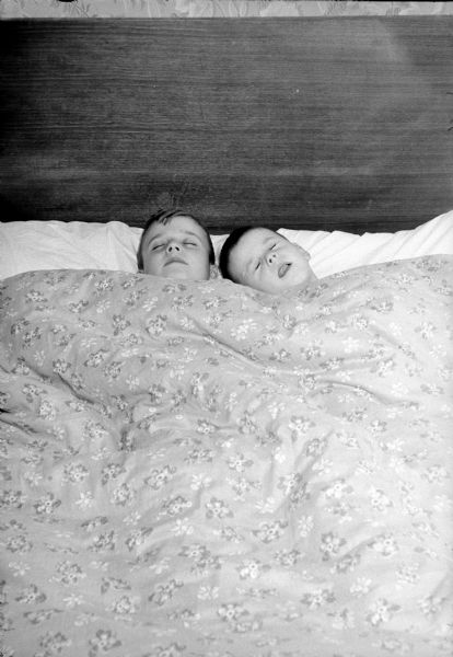 Jeff and Gregg Anderson snuggled in bed ready to dream of Christmas toys before visiting the Wolff-Kubly-Hirsig store, Toyland.