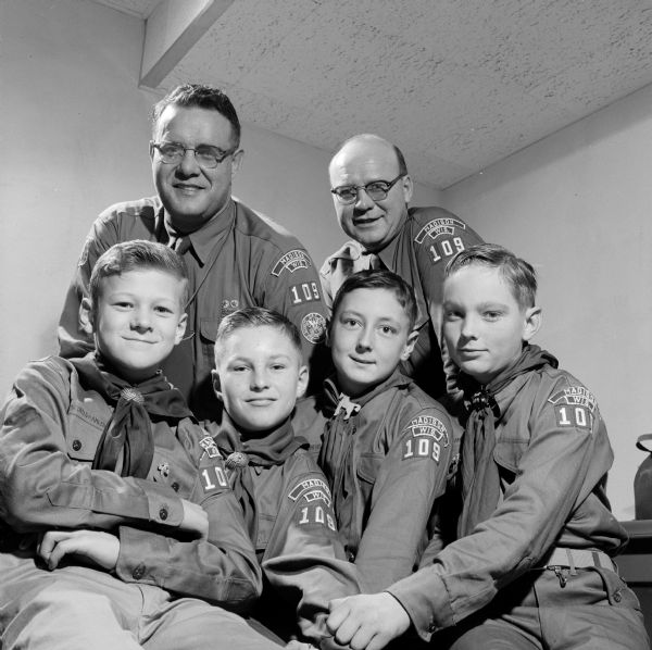 Scoutmaster Roy Burton and assistant Allen Wornson with four Boy Scouts displaying their Troop 109 shoulder patches. The boys from left to right are: Tom Sailor, Lloyd Dresen, and Bob McDonald. (One boy is not named.) 