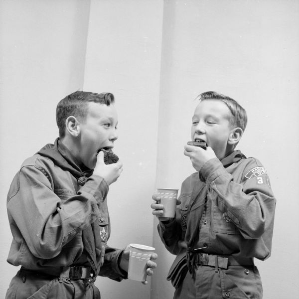 Two Boy Scouts enjoying some cake at the initial meeting of Troop 109 at Lakeview Community Church. They are Dick Severan (left) and Tom Severan.