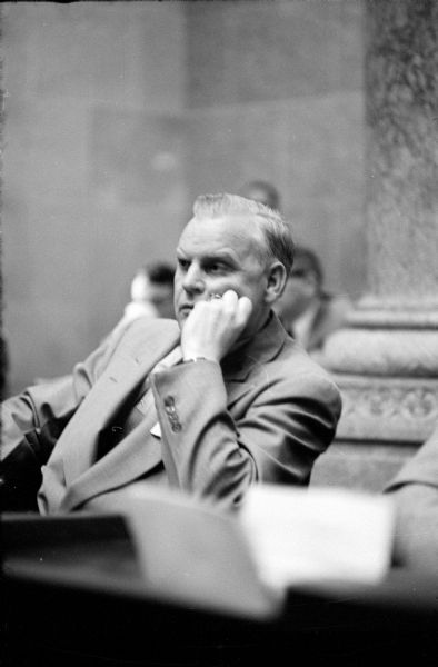 Assemblyman Earl Warren (D-Racine) is listening to a presenter at the pre-session lawmaker's school for the freshman members of the 1955 Wisconsin State Legislature.