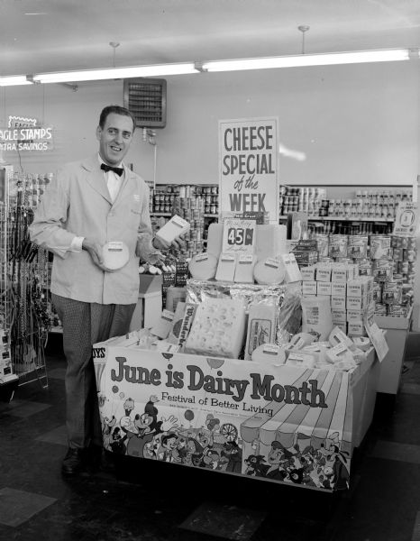 June is Dairy Month display at National Food stores located at 2087 Atwood Avenue, promoted by a grocer holding up the cheese special of the week.