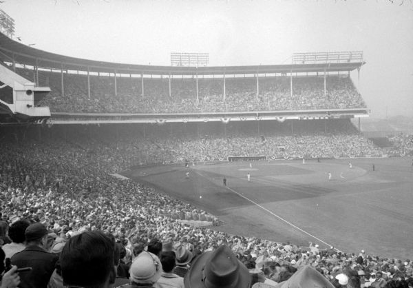 View of the 43,640 baseball fans at Milwaukee County Stadium where the Milwaukee Braves baseball team played the Cincinnati Redlegs in the season opener. The Braves won 4 to 2.  