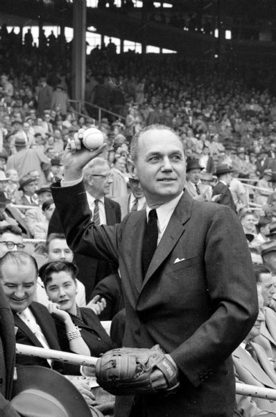 Wisconsin Governor Walter Kohler ready to throw out the first pitch of the 1955 season to Milwaukee Braves catcher Del Crandall. Pictured in the lower left hand corner is Senator Joseph R. McCarthy. The Braves won the game 4 - 2. 