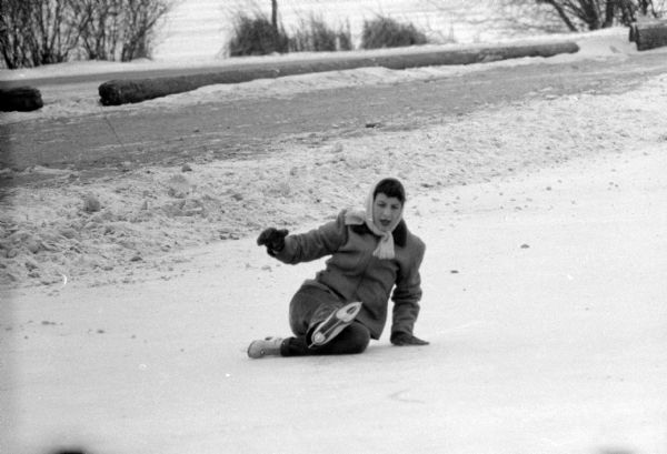 Ice skater falling on her bum at Vilas Park ice rink on Lake Wingra.