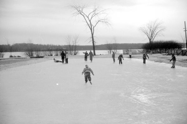Ice skaters on the Vilas Park ice rink by Lake Wingra.