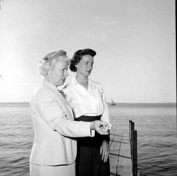 Two women posing on a dock on Lake Mendota. They are Ruth La Duke (left), acting director of the YWCA's health education department, and Ruth Edie, who was in charge of the summer young adult program. The program offered "classes in popular summer sports and planned activities for warm weather fun."