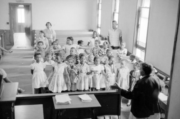 Children learning a song in the two-week summer Bible school at the St. Paul African Methodist Episcopal church located at 631 East Dayton Street.