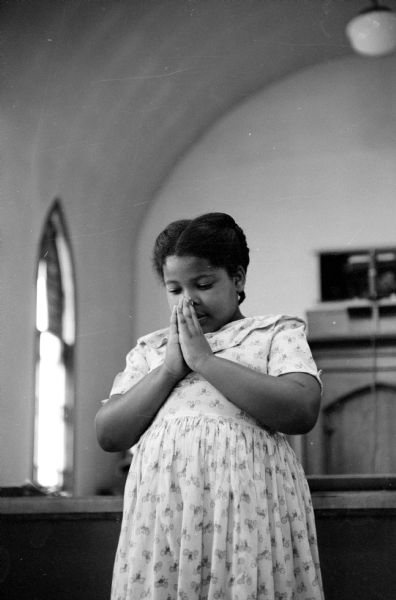 Patsy Caire praying at the two-week summer Bible school at St. Paul African Methodist Episcopal church located at 631 East Dayton Street.
