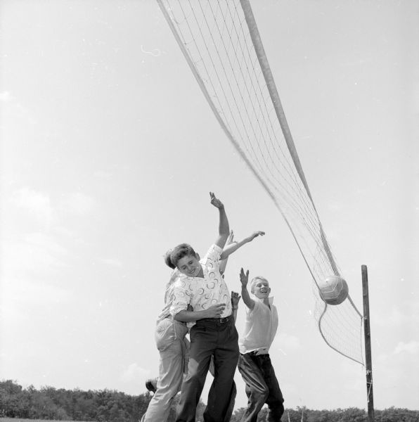 <i>Wisconsin State Journal</i> carriers Lloyd Briggs and Harold Joyce attacking a volley ball at Blue Mounds State Park. The partially obscured boy is unidentified.