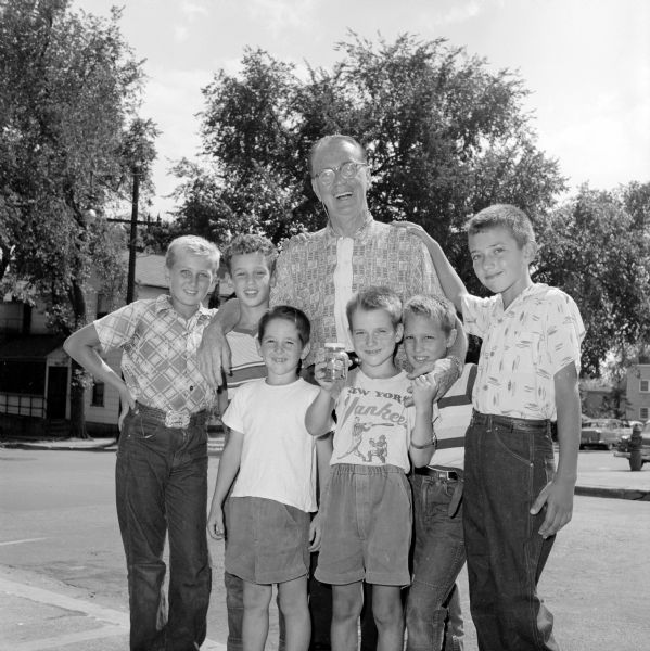 Roundy (Joseph Coughlin) posing with six boys who hosted a backyard carnival to raise $7 for "Roundy's Fun Fund" benefiting children with physical disabilites. The boys are (left to right): Larry Ozanne, Jeff Bartell, Tommy Dumphy, Jimmy Dumphy, Denis Bartell and Bobby Luchsinger.