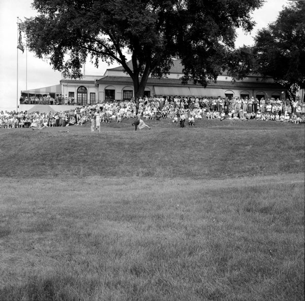 The Maple Bluff Country Club clubhouse with a crowd watching the 26th Annual Women's Western Open.
