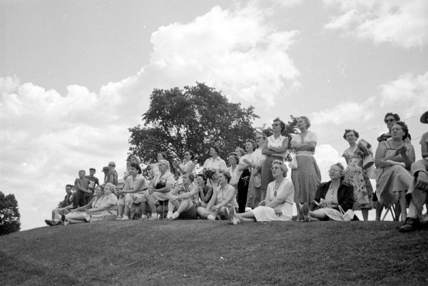 Women spectators watch as a field of 20 professionals and 50 top amateurs began a 72-hole competition in the 26th Annual Women's Western Open golf championship at the Maple Bluff Country club.