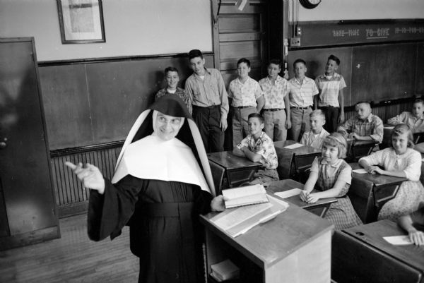 Sister M. Cordis, 7th & 8th grade teacher and principal at Holy Redeemer Catholic School located at 128 West Johnson Street, points out to her class a lesson written on the blackboard. About 150 students registered to attend the school during the 1955-1956 school year.