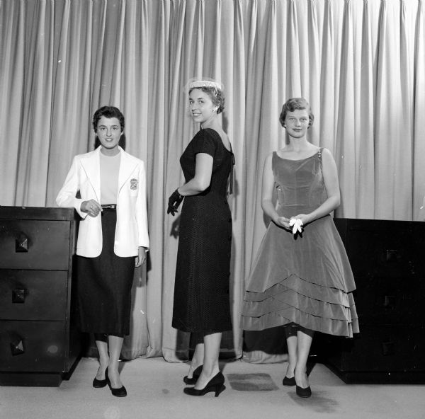 Three graduating seniors model clothing especially suitable for college life at the tea sponsored by the Madison Alumnae Panhellenic Council. The models are (left to right): Frances Hand, Barbara Marshall and Mary Fenske.