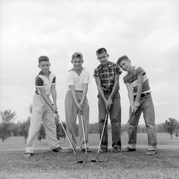 Four of the young stars taking part in the city inter-club junior golf tournament at the Nakoma Country Club. They are (left to right): Rick Radder, Dick Gallagher, Tom Stevens, and Jeff Leonard.