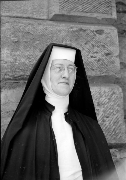 Attending a convocation session of the Wisconsin Congress of the Confraternity of Christian Doctrine at St. Raphael Cathedral is Sister Mary Ardina, Sisters of St. Dominic (Racine) in Roxbury, Wisconsin. She is wearing a wimple under her black veil. 