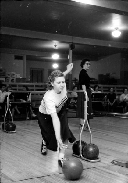 Jean Jackson releasing a bowling ball at a gathering of blind bowlers at Playdium Alleys. She is one of about fifteen visually impaired participants who gather weekly on Tuesdays at Playdium Alleys located at 112 North Fairchild Street. None of the participants has vision better than 10 percent.