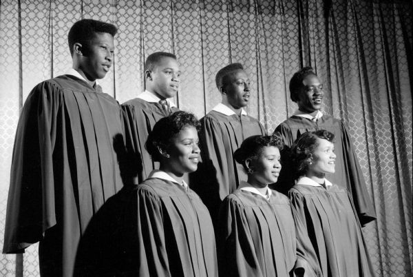 Madison Women's Club presents an original play "Man and His God' to raise money for scholarships. Members of one of the play's choirs provides musical background. In the first row (left to right) are: Miss Henrietta Sanders of 909 Milton Street; Miss Jeanette Braxton of 2000 Fisher Street; and Miss Shirley Doss of 106 S. Murray Street. In the back row are four young men stationed at Truax Field (left to right): James DeVire (Los Angeles, California); Timothy Rumph (Orangeburg, South Carolina); Ronald Harrison (Los Angeles, California); and William F. Baker (Cleveland, Ohio).   