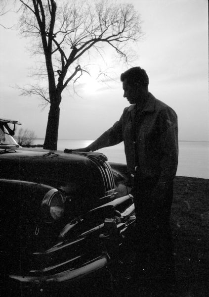 Jerry Ball of Portage waxes his car at Tenney Park during his break from work. Lake Mendota is in the background.
