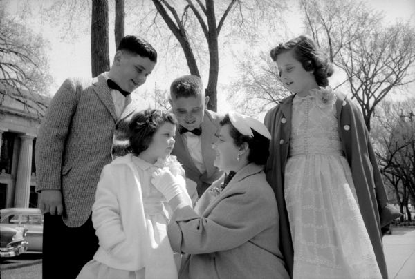 Mrs. P. Houston adjusting a flower on the coat of daughter Marjorie on the way to Bethel Lutheran Church on Easter Sunday. Her other children are Howard, Joe, and Carolyn.