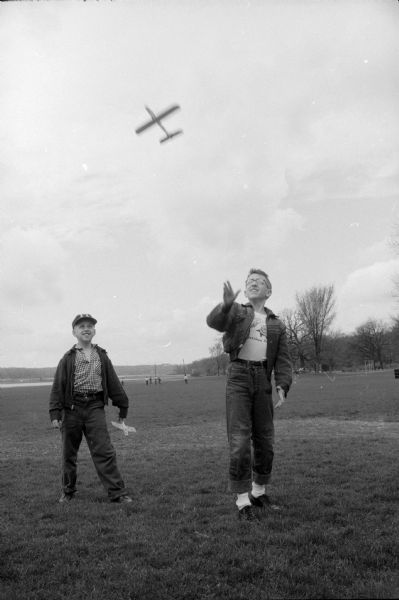 Teddy (age 8) and William Buenzli (age 10) of 1820 Vilas Avenue enjoy a spring day flying homemade planes at Vilas Park.