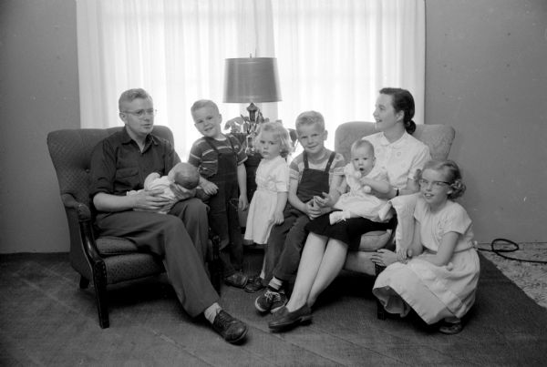 Edith and Lawrence Anderson have two foster children who are living with their family temporarily. Pictured are the Lawrence family with their two foster children.  From left to right are Lawrence Anderson holding one of the foster children; Jimmy Anderson; Barbara Anderson; David Anderson; Edith Anderson holding the other foster child, and Linda Anderson.