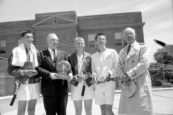 Wisconsin Interscholastic Athletic Association tennis champions with their coaches. Neenah coach Ivan Williams is standing between doubles champions Tom Zeuthen (left) and Dick Westphal. Wauwatosa coach Ben Peacock (right) is standing next to singles champion John Iglehart.