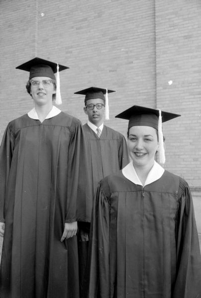 Three Edgewood High School seniors who will receive awards at the school's commencement ceremony. From left are Mary Doyle who will receive the Kelsey award, Joseph Kehm who will receive a Knights of Columbus Christian manhood award, and Patricia Putnam who will receive a Rotary Club award. All are wearing their mortarboards and gowns. 