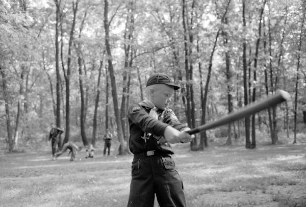 Michael Smith swings a bat during a baseball game at a picnic for Cub Scout Pack #321, Den #6.