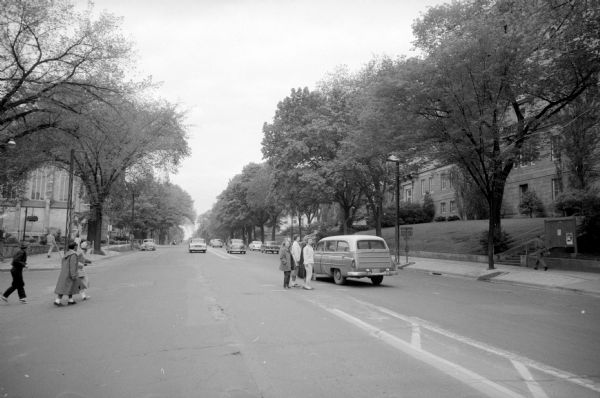 Pedestrian safety islands at University Avenue and Brooks Street were raised concrete islands (referred to as "meat-blocks") and are being removed to possibly be replaced with flat islands, if considered necessary. Students are seen waiting in the middle of the road for traffic to pass. 