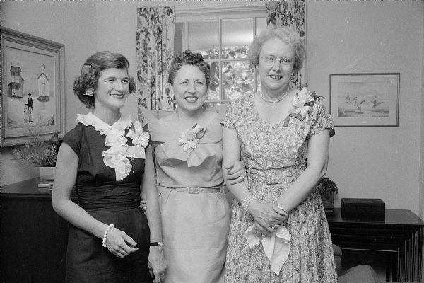 Members of the PEO (Philanthropic Educational Organization) Sisterhood Reciprocity Board hold a tea in honor of First Lady Helen (Davis) Thomson, wife of Wisconsin Governor Vernon W. Thomson, and Mrs. A.E. Hatch (Fond du Lac), State PEO president. Left to right are: Mrs. James F. Land (710 Huron Hill), president of the Reciprocity Board; Mrs. Thomson; and Mrs. Hatch. All three women are wearing corsages. 