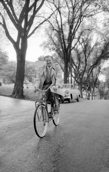 Circuit Judge Richard W. Bardwell riding home on his new English bicycle -- his answer to the downtown parking problem.