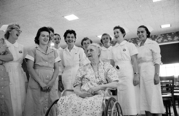 Madison General Hospital nurses singing "Happy Birthday" to Gunda Benson,  who is seated in her wheelchair and surrounded by the group.