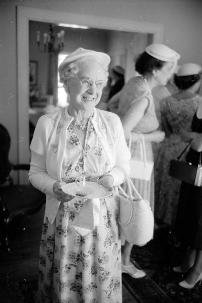 Minnie Hastings enjoying a cup of punch and some cookies at the annual missionary tea sponsored by the Women's Society of Christ Presbyterian Church. It was held at the home of Eleanore Conlin at 739 Farwell Drive.